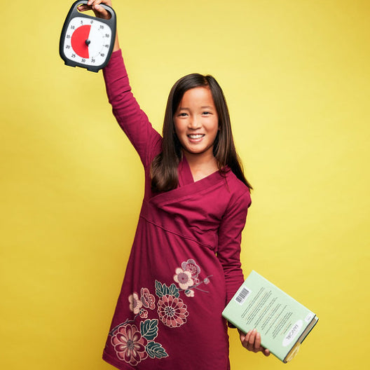 Young girl holding Time Timer® in the air