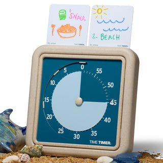 The Time Timer RETRO Eco Edition timer is shown with two Dry Erase Activity Cards across the top. The first one reads "1. Snack" and the second card reads "2. Beach", implying a first/then schedule. 