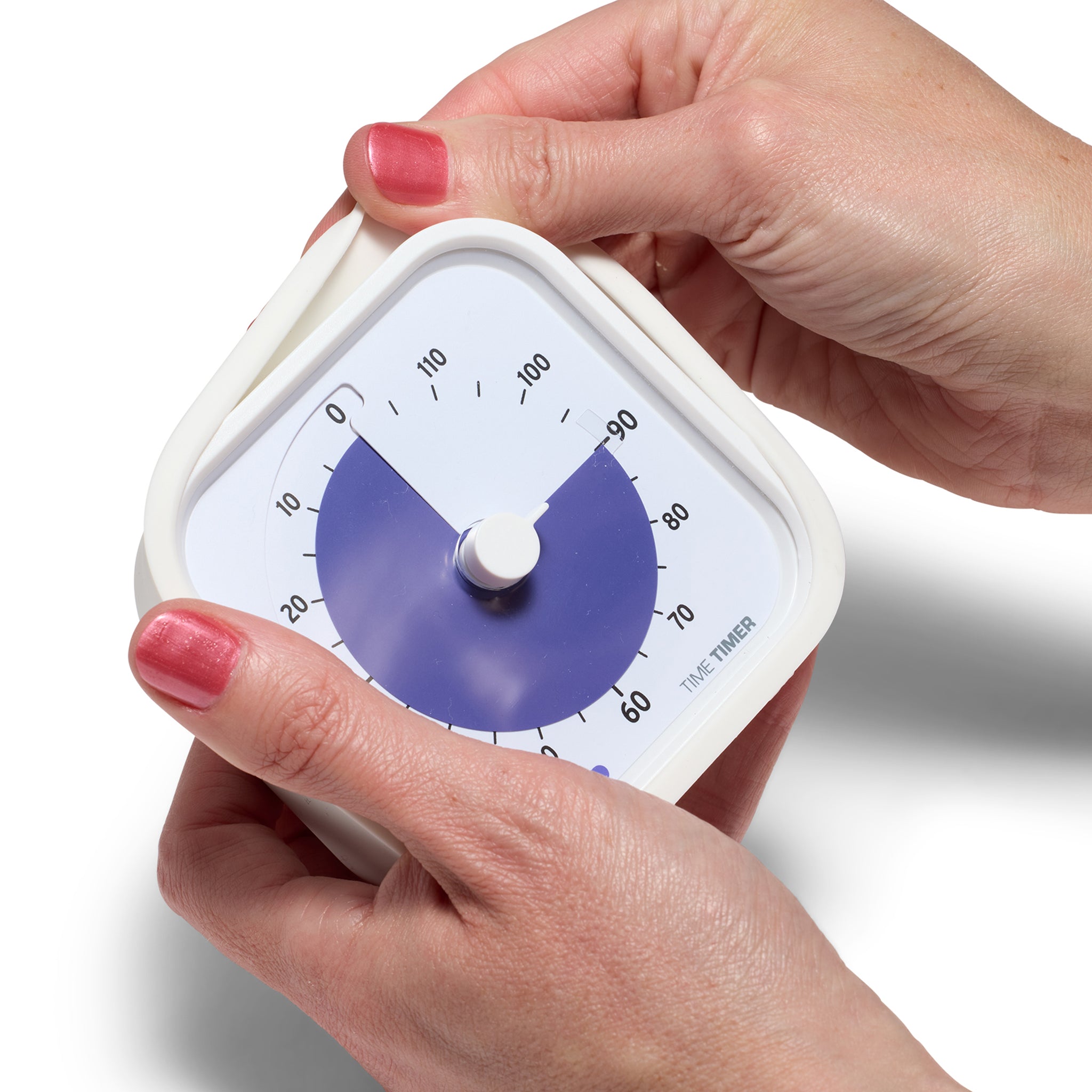 The Time Timer MOD 120 Minute Education Edition timer is being held by two hands. With one hand, the white silicone case is being peeled off of the timer. 
