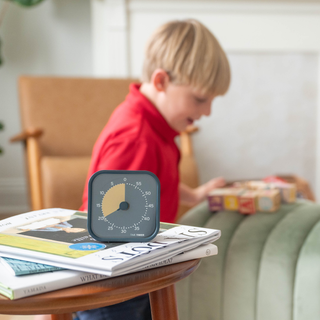 A child playing using the 
Time Timer® MOD Home Edition Metallic Midnight as a timer for play time. 